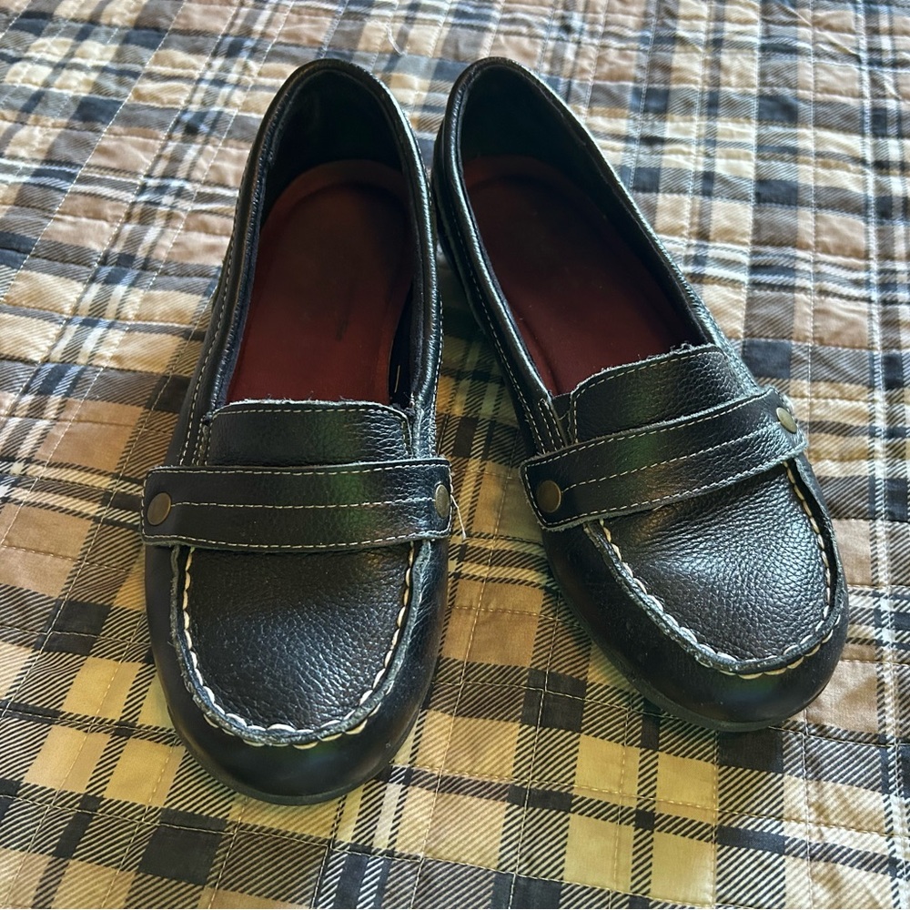 Black women’s Skechers leather slip-on shoes
